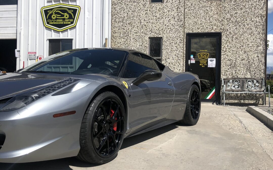 Sliver sports car parked outside DE Performance LLC auto reparir shop